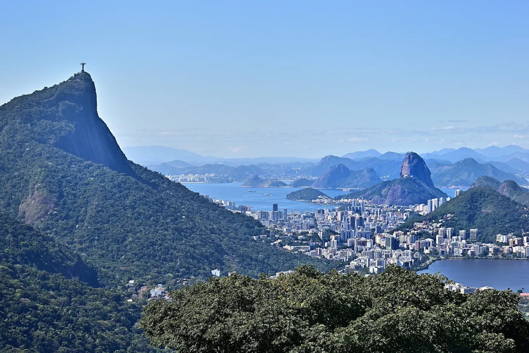 Corcovado Mountain with Christ the Redeemer at the top and, in the background, the city of Rio, the bay, and Sugarloaf Mountain