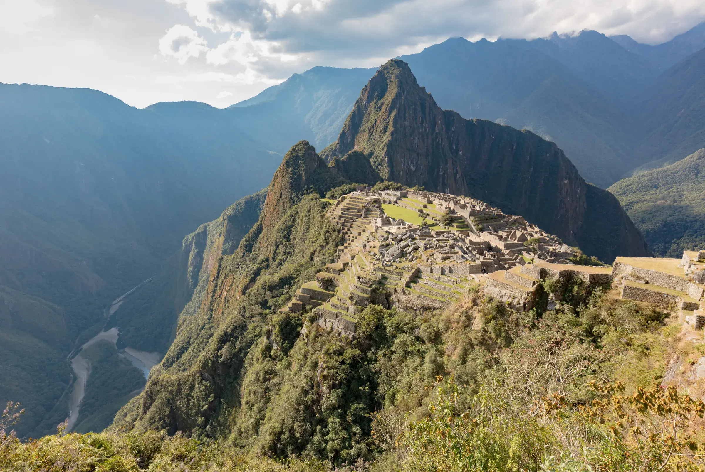 Inca citadel of Machu Picchu on an Andean mountaintop, with Huayna Picchu peak in the background and the Urubamba Valley
